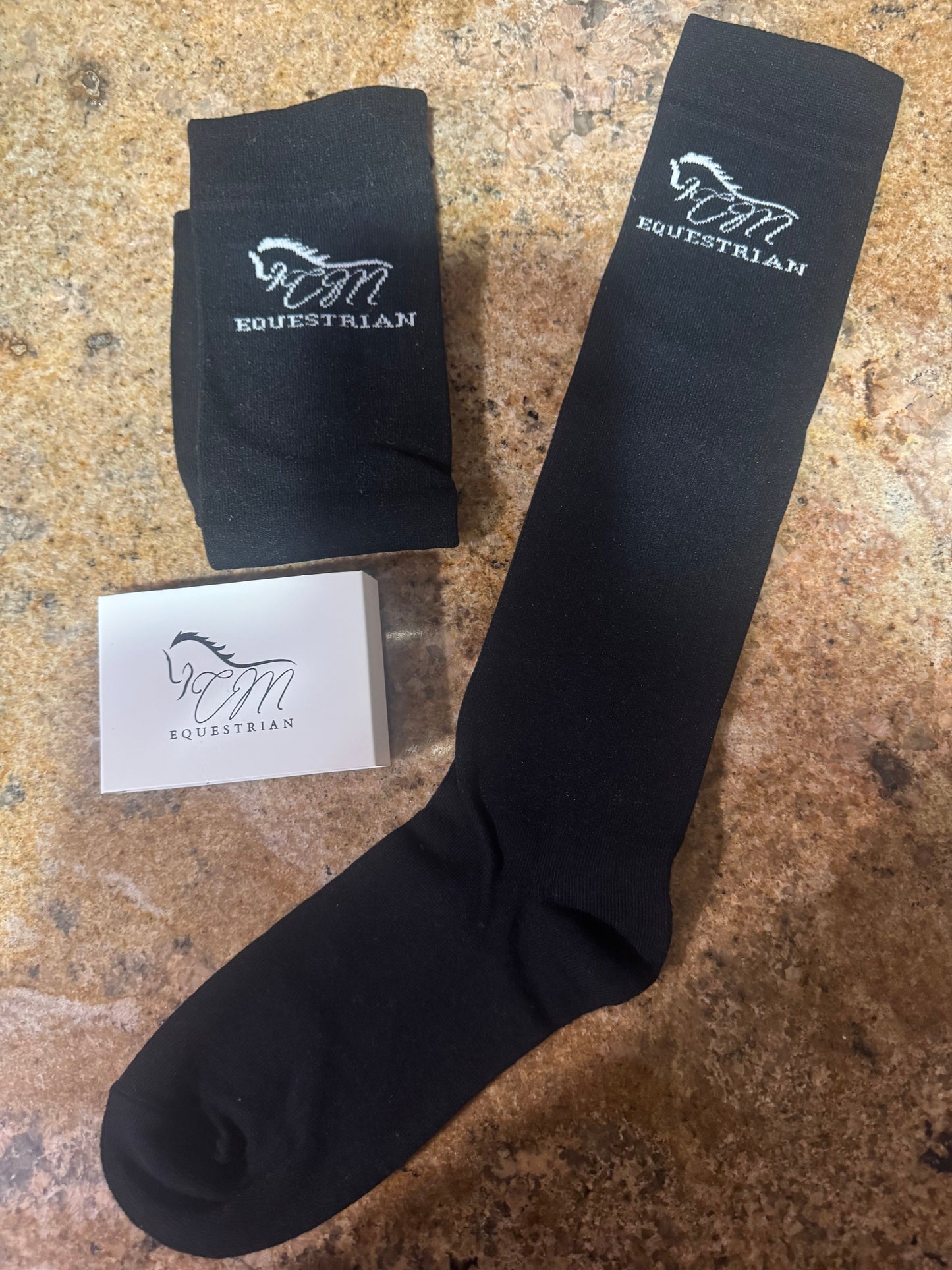 CM equestrian logo socks in black with White logo on the side.